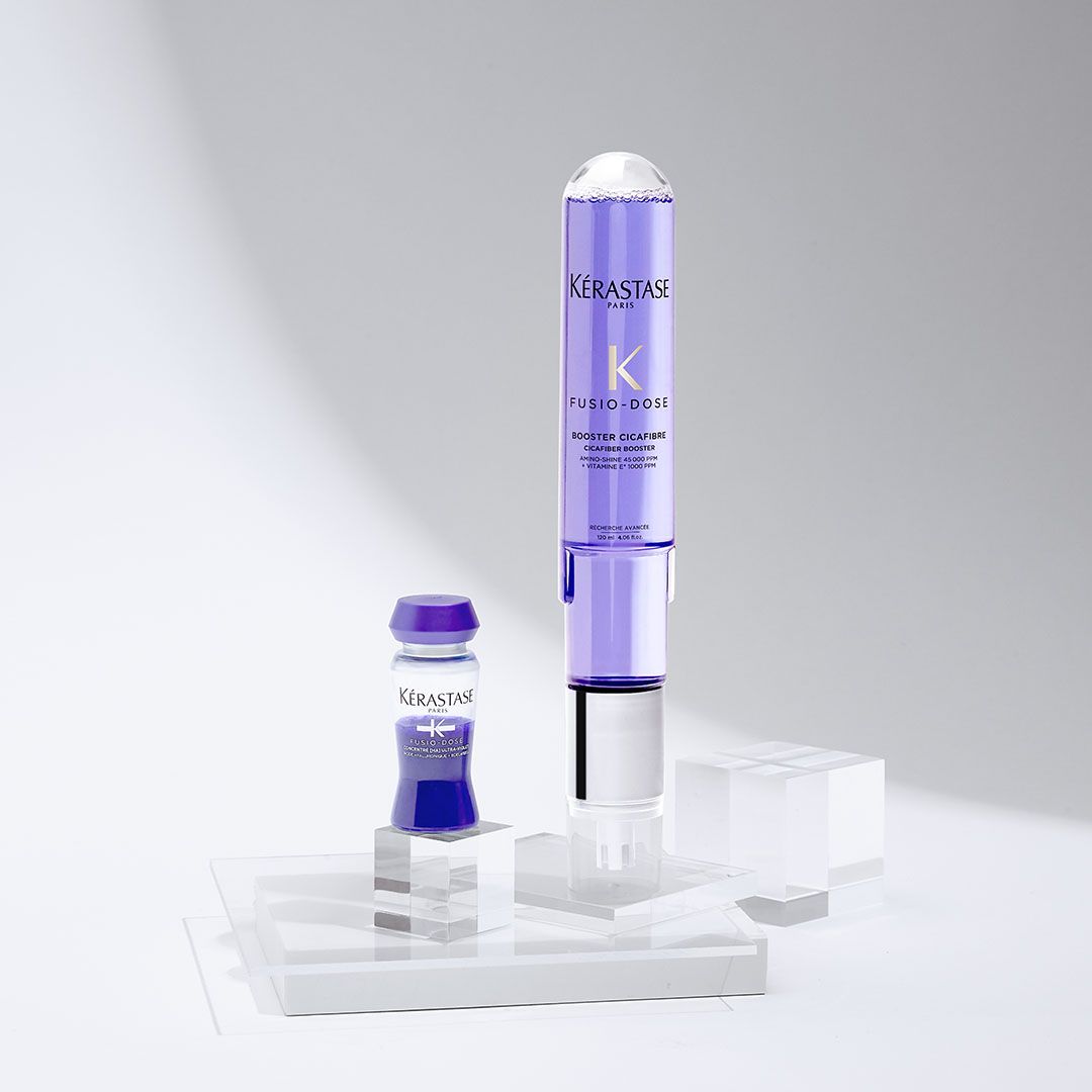 A bottle of shampoo and a bottle of conditioner are sitting on a table