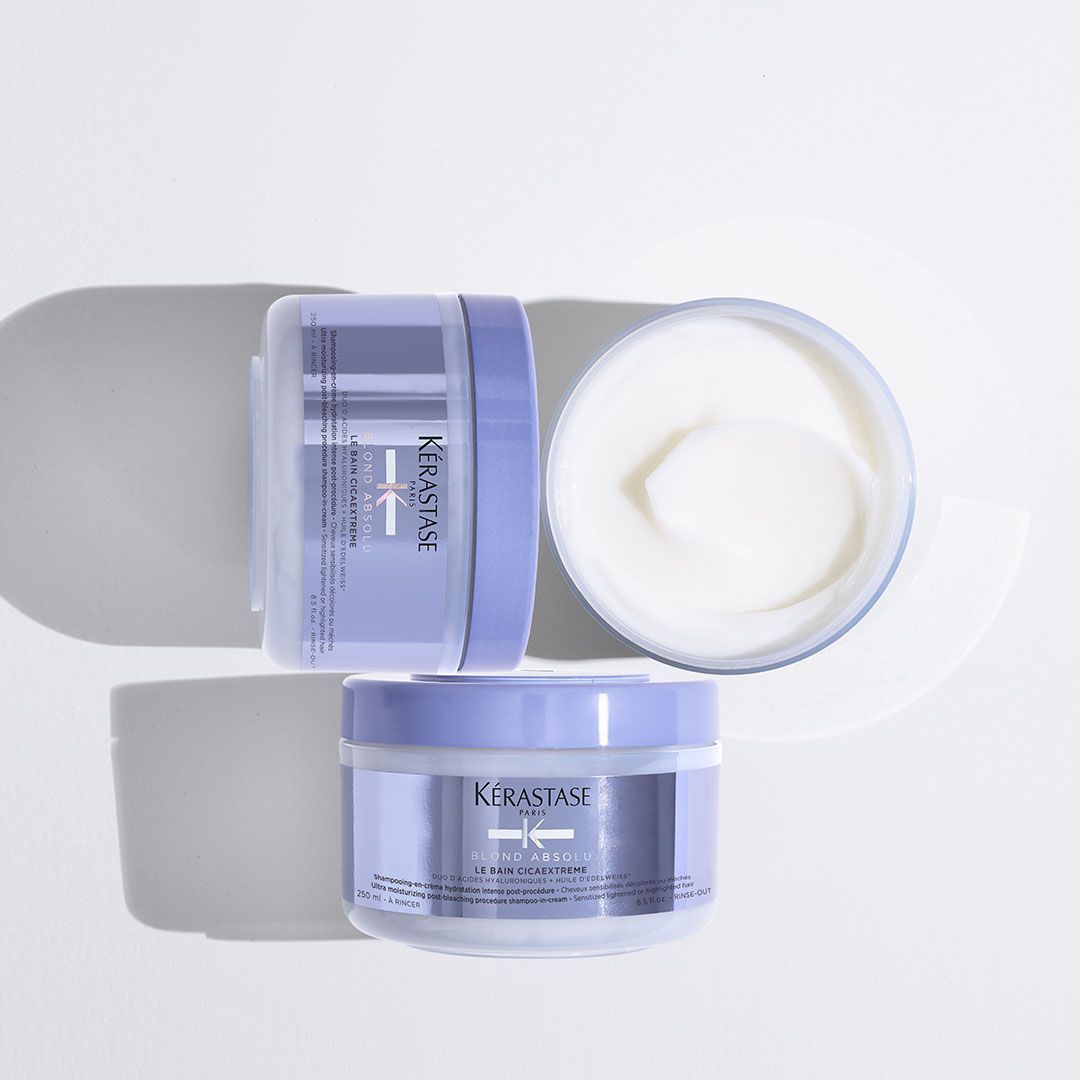 Two jars of Kérastase hair products on a white surface