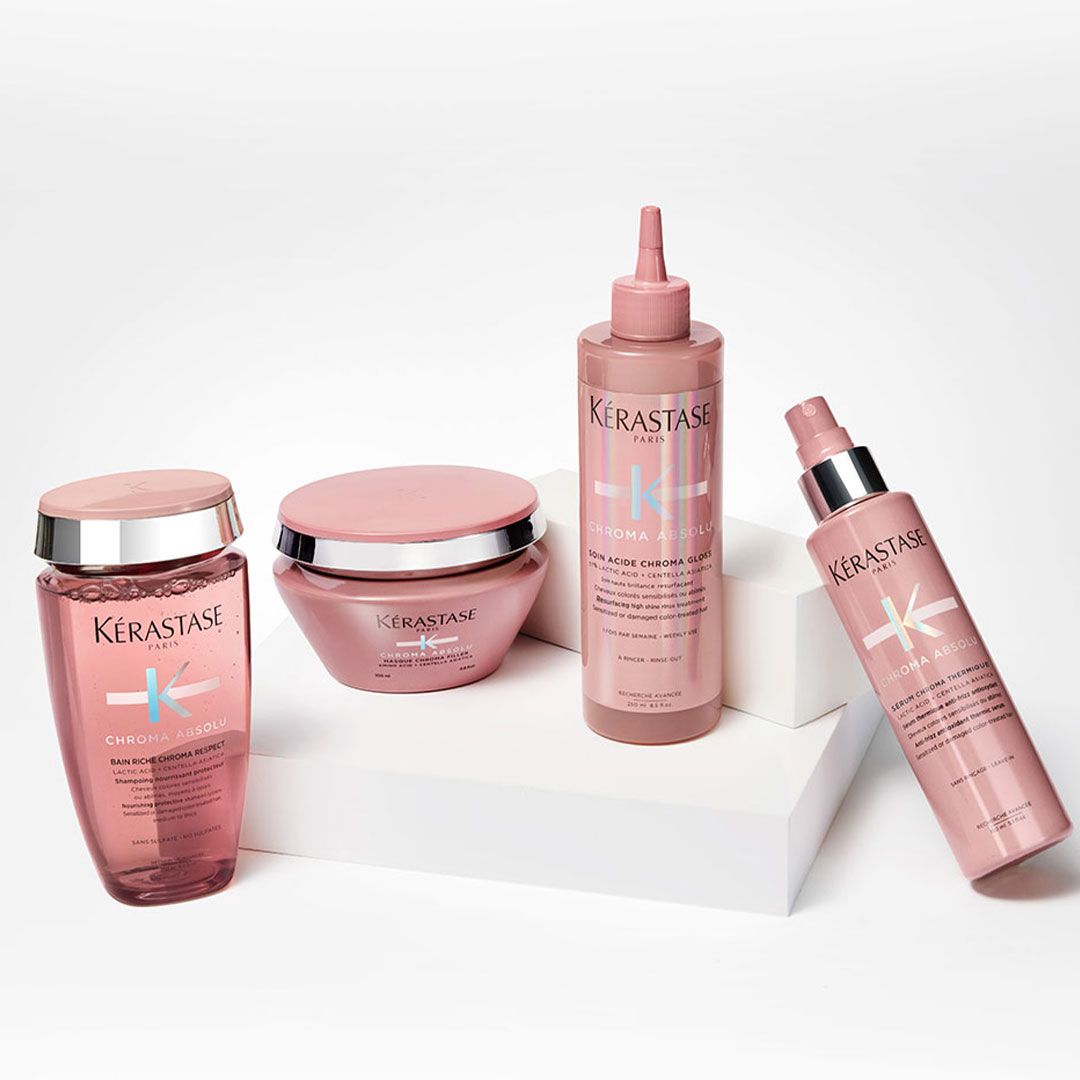 A group of hair products sitting on top of each other on a table