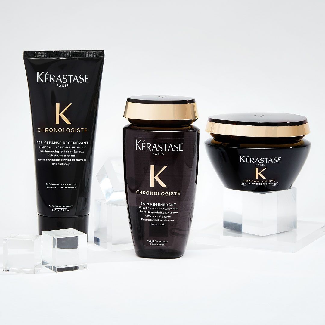 Three bottles of kerastase hair products are sitting on a table