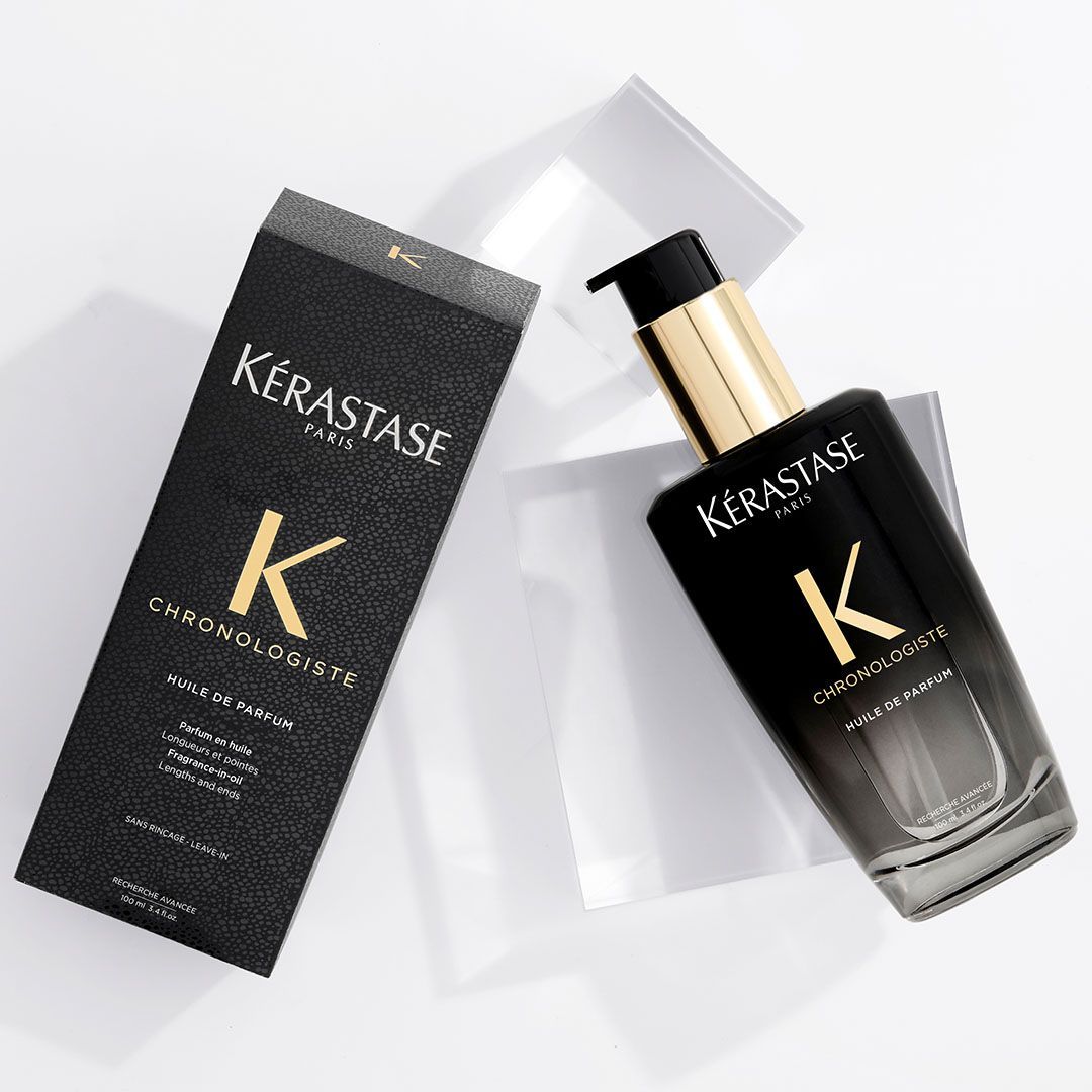 A bottle of Kérastase hair product next to a box