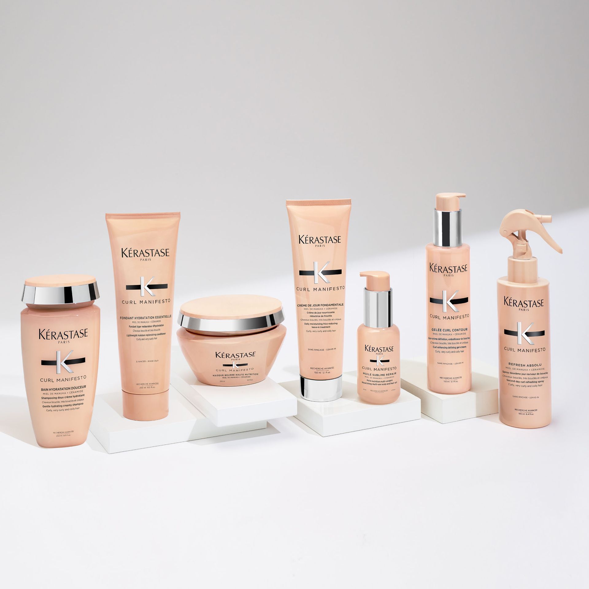 A variety of Kérastase hair products are lined up on a table