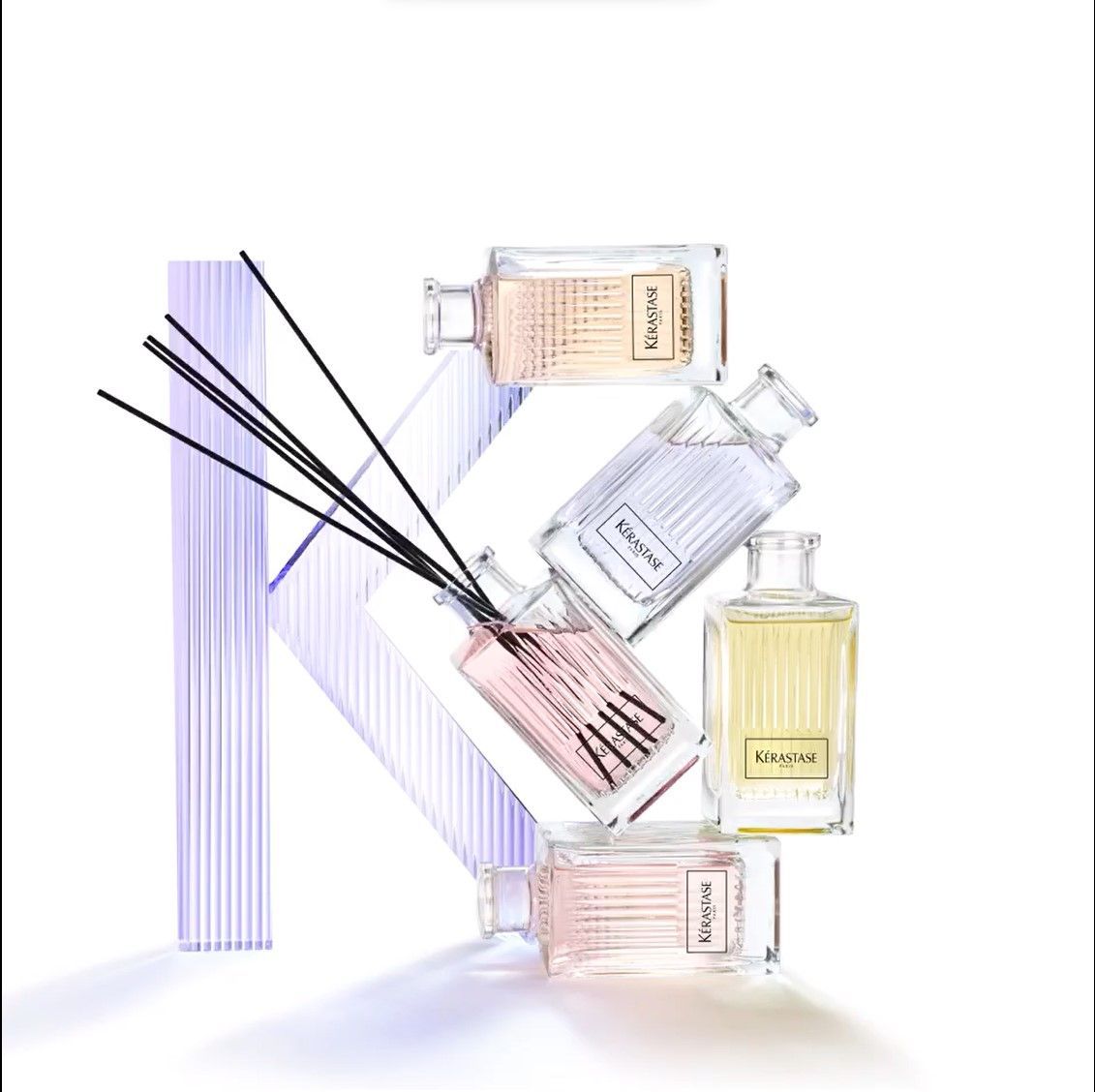 Bottles of perfume are arranged in the shape of the letter K