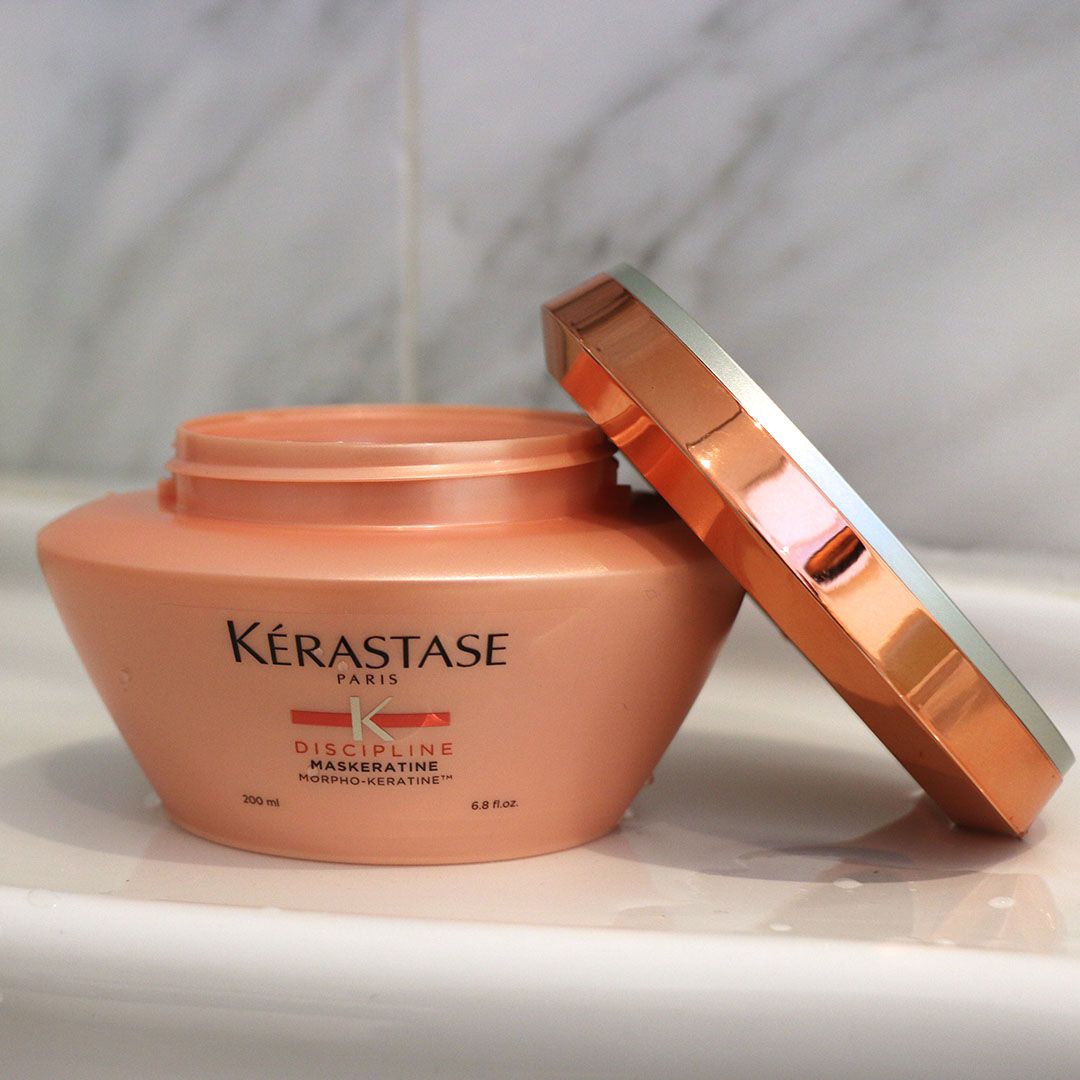 A jar of Kérastase hair product sits on a sink