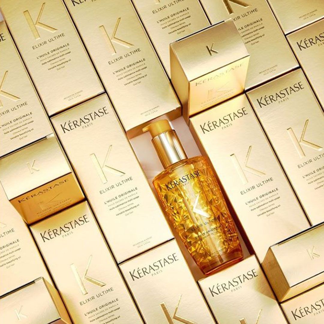 A bottle of Kérastase hair product is surrounded by boxes
