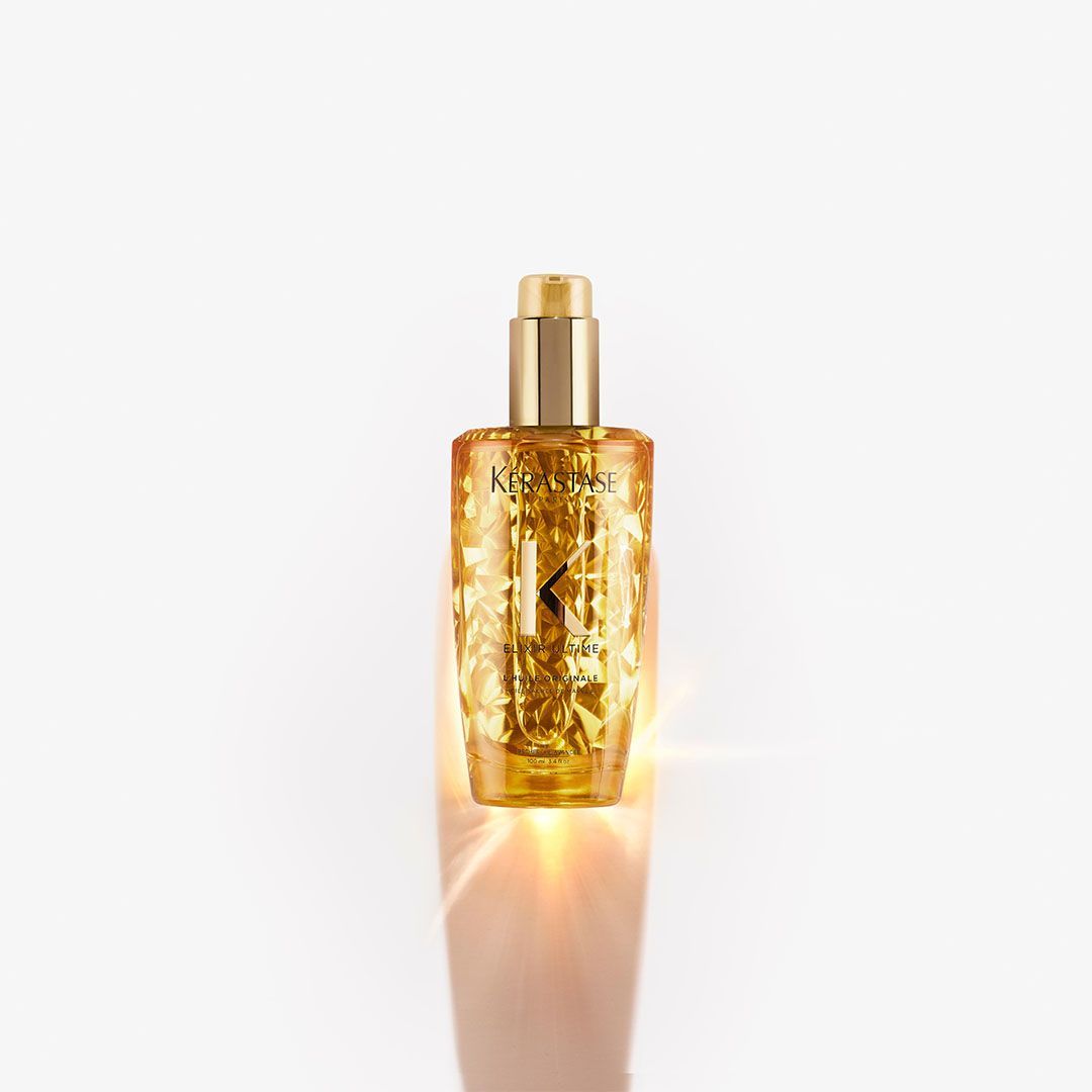 A bottle of perfume is sitting on a white surface