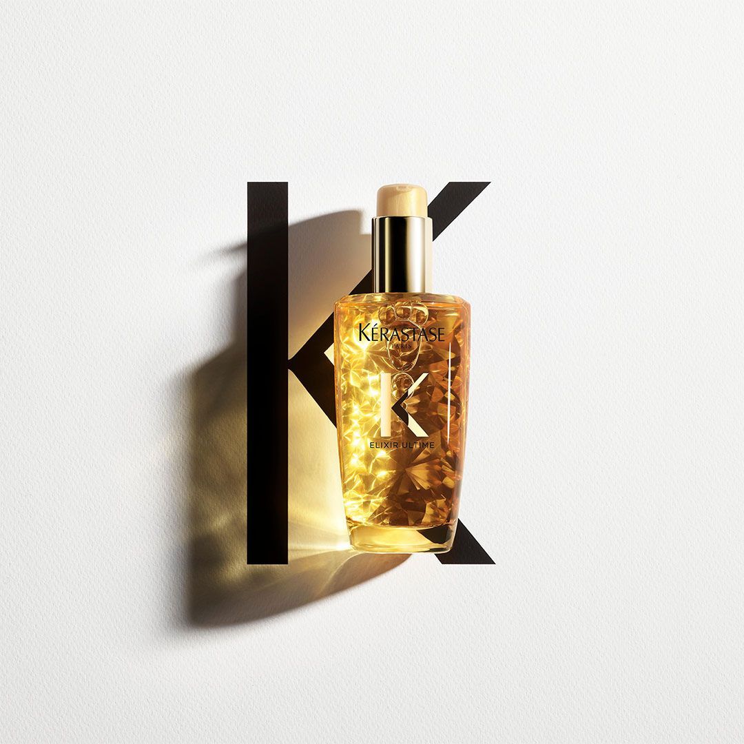 A bottle of perfume with the letter K on it