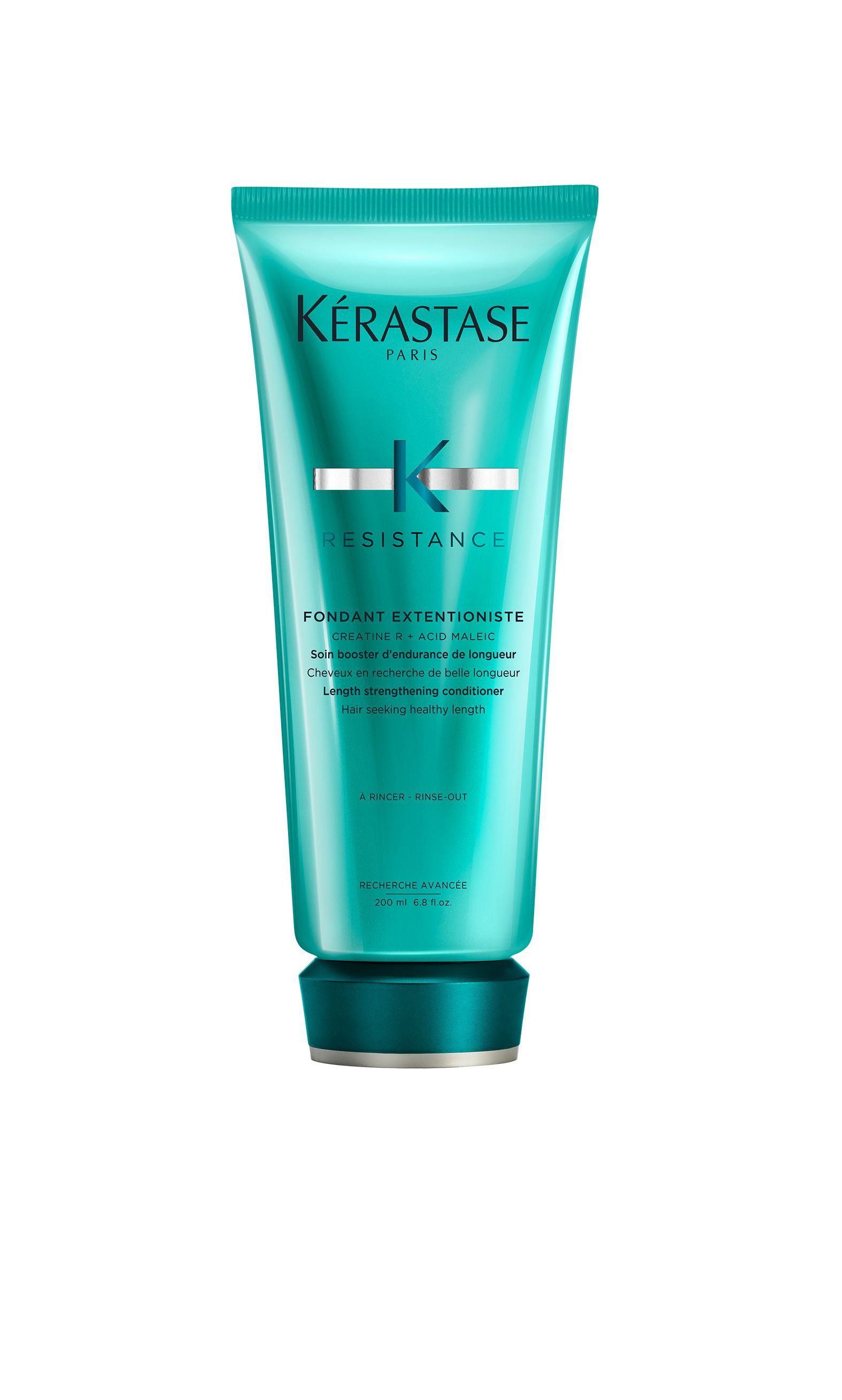A bottle of Kérastase hair product on a white background