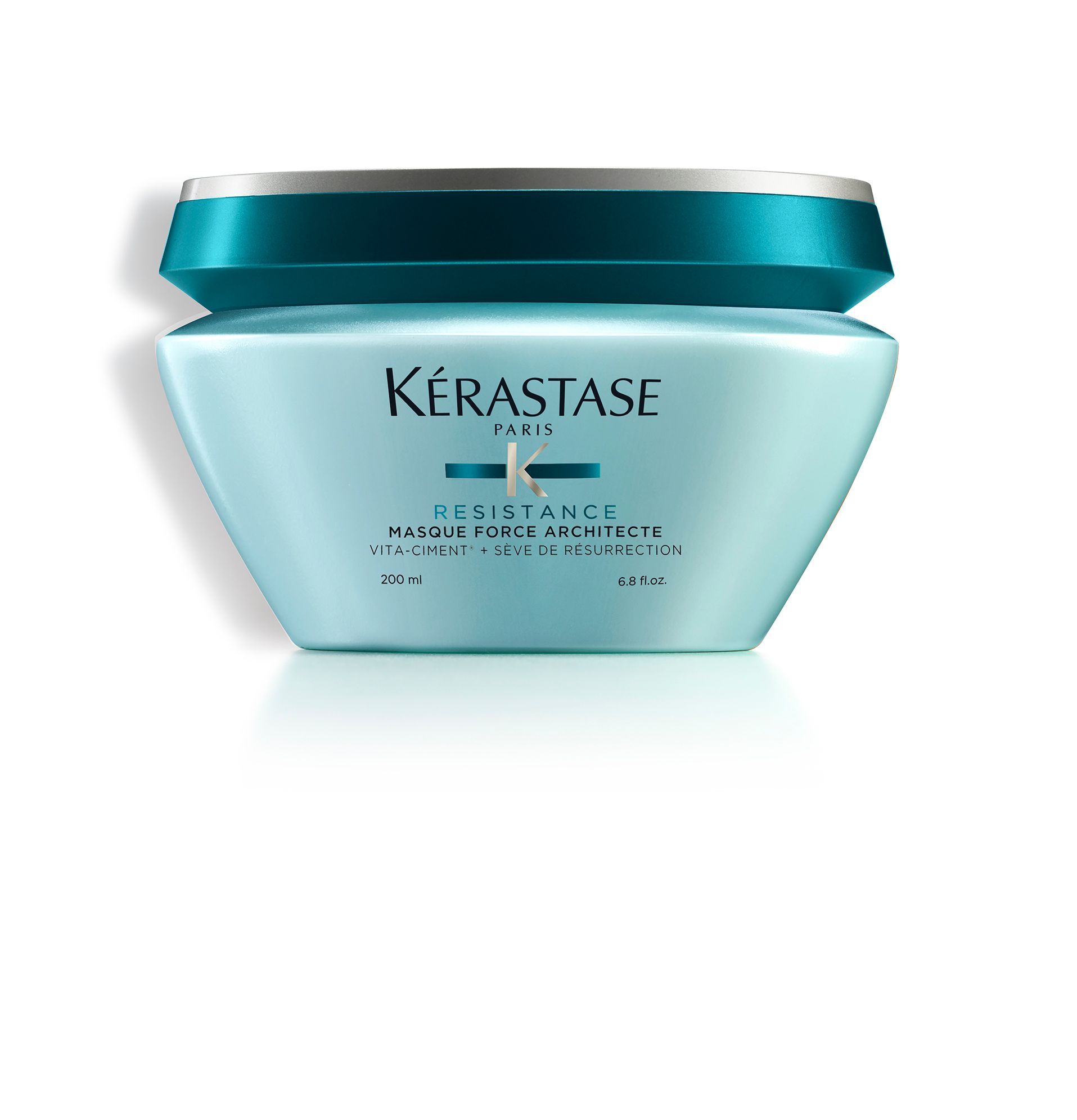 A blue jar of Kérastase hair product on a white background