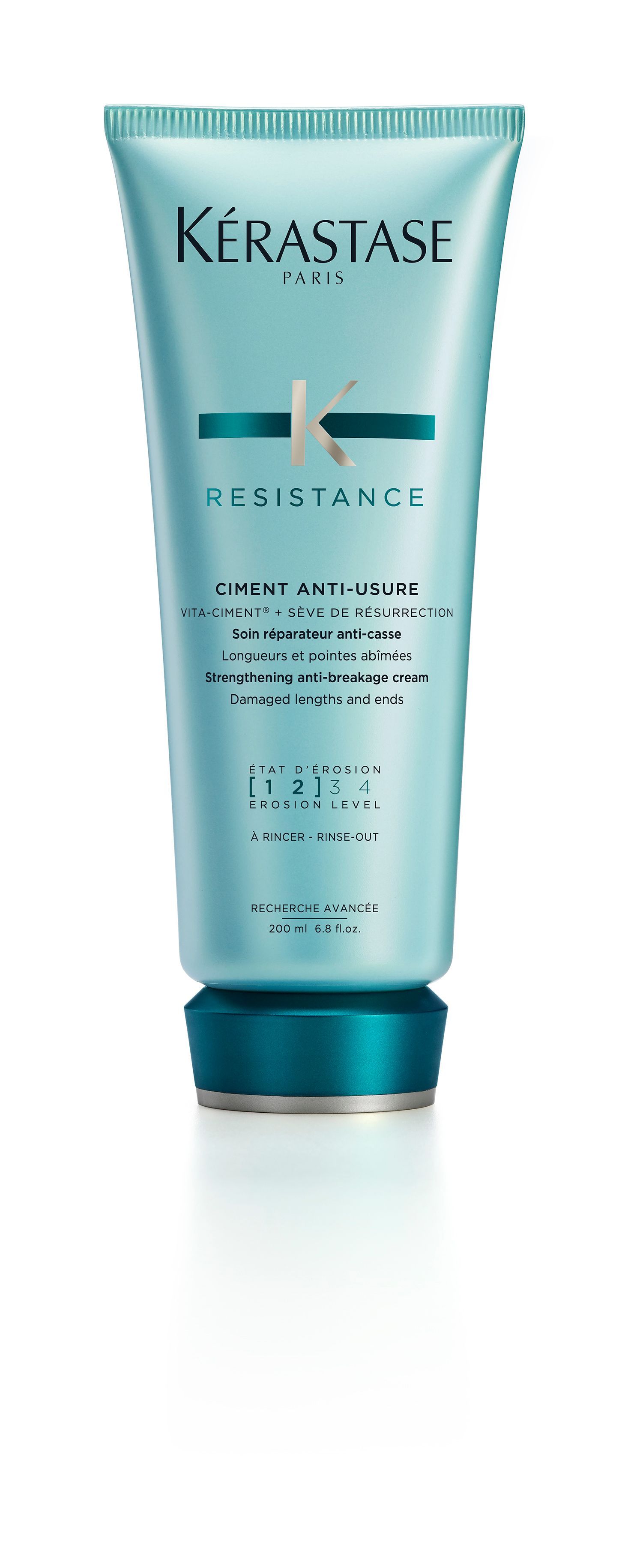 A bottle of Kérastase resistance conditioner on a white background