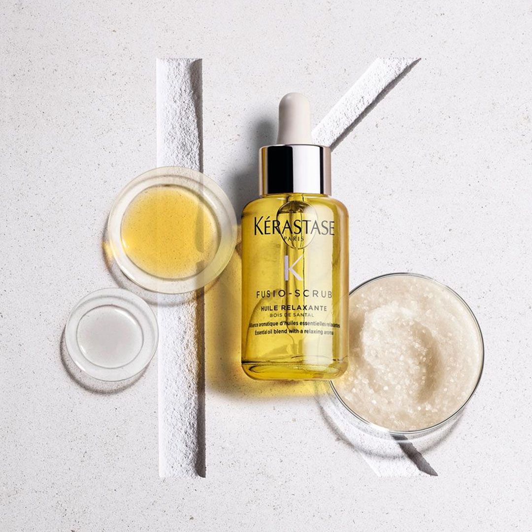 A bottle of Kérastase hair oil with a dropper