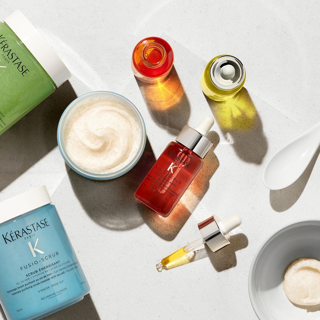 A table topped with bottles of Kérastase products