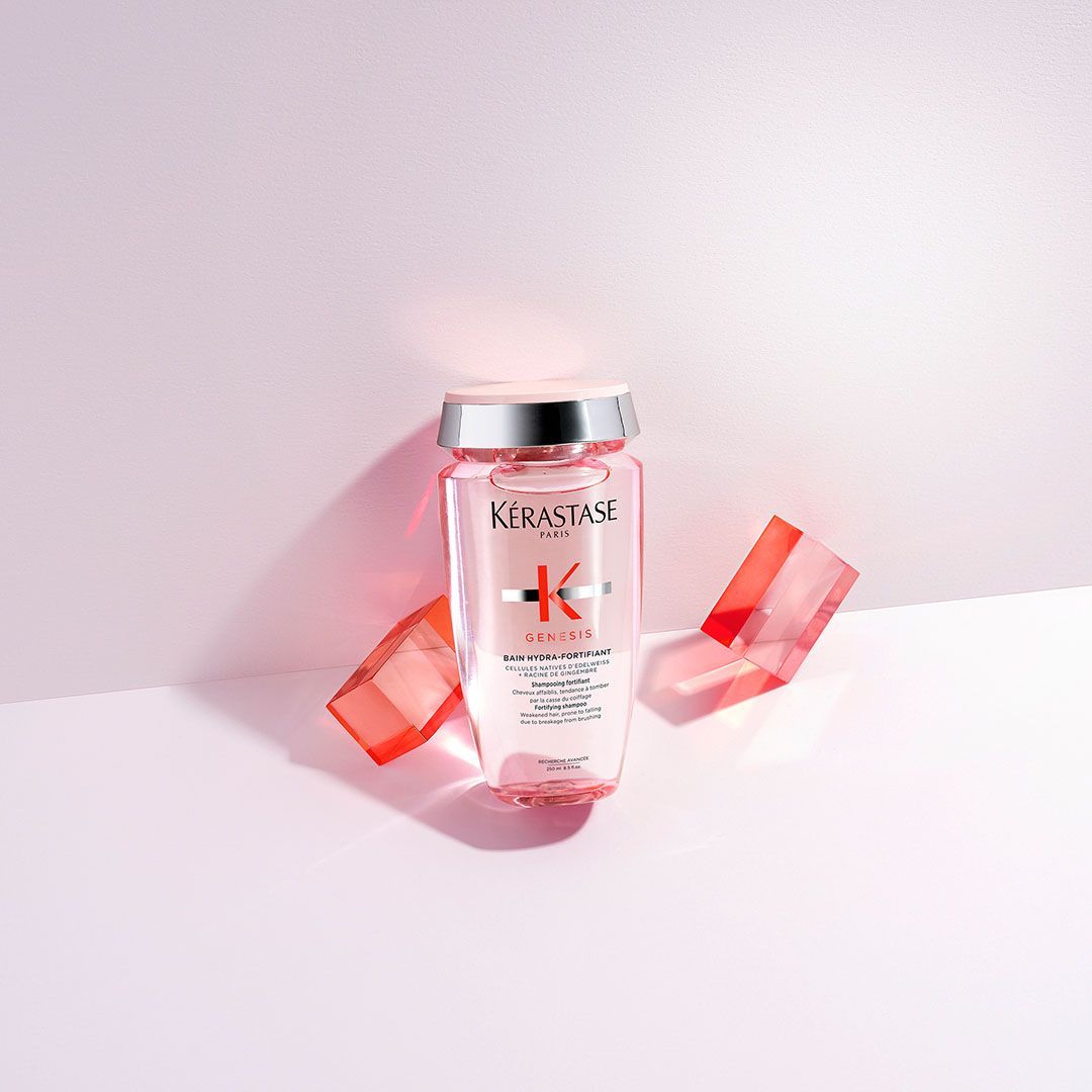 A bottle of Kérastase shampoo is sitting on a table