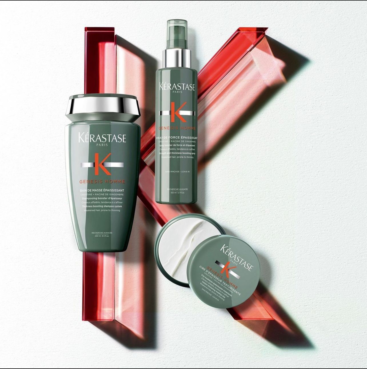 Three bottles of Kérastase hair products on a white surface