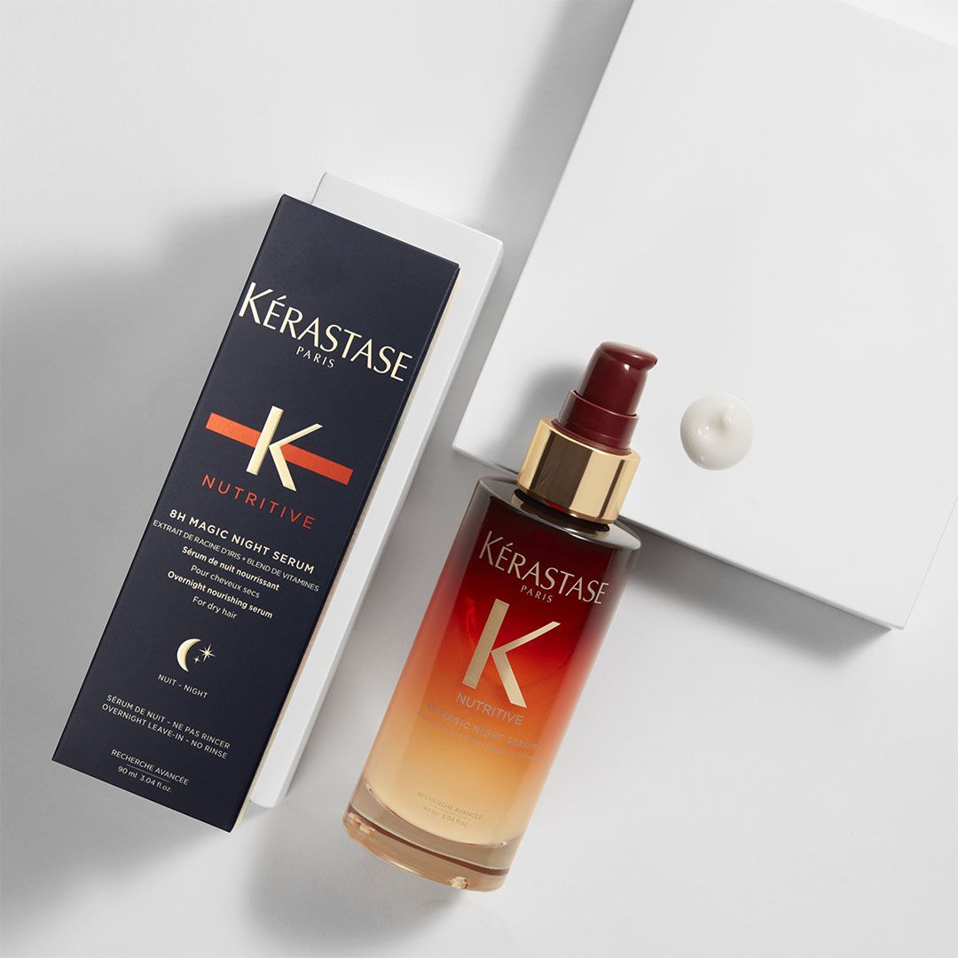 A bottle of Kérastase is next to a box on a table