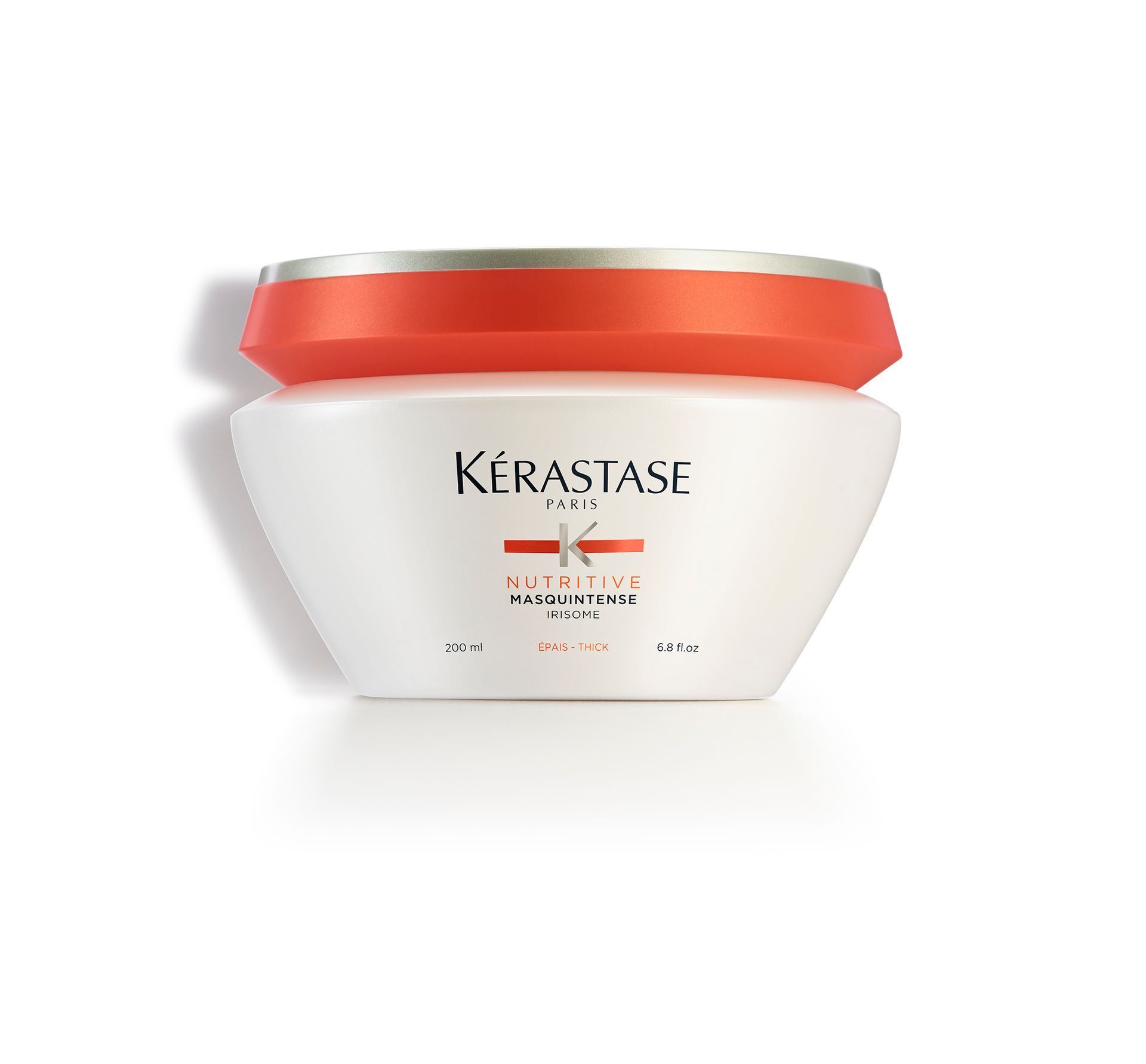 A white Kérastase product with a red lid