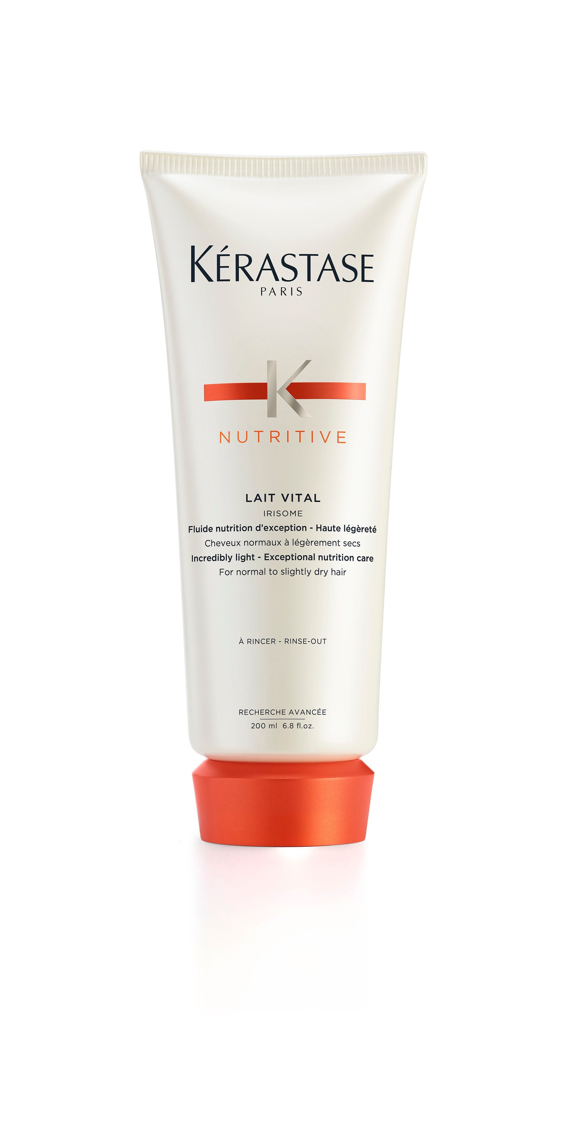 A bottle of Kérastase hair product on a white background