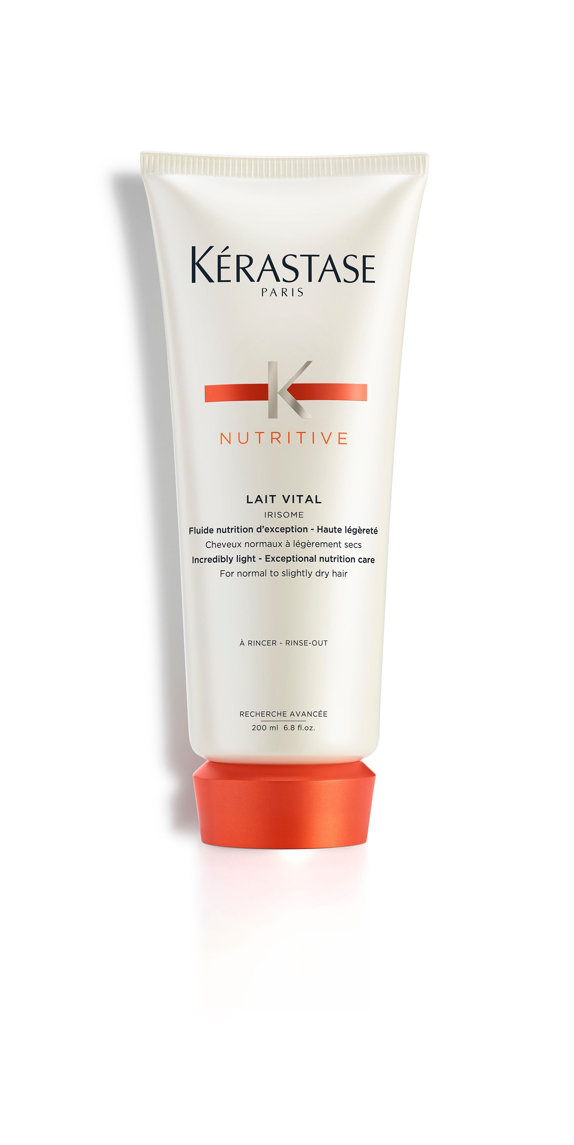 A bottle of Kérastase hair product on a white background