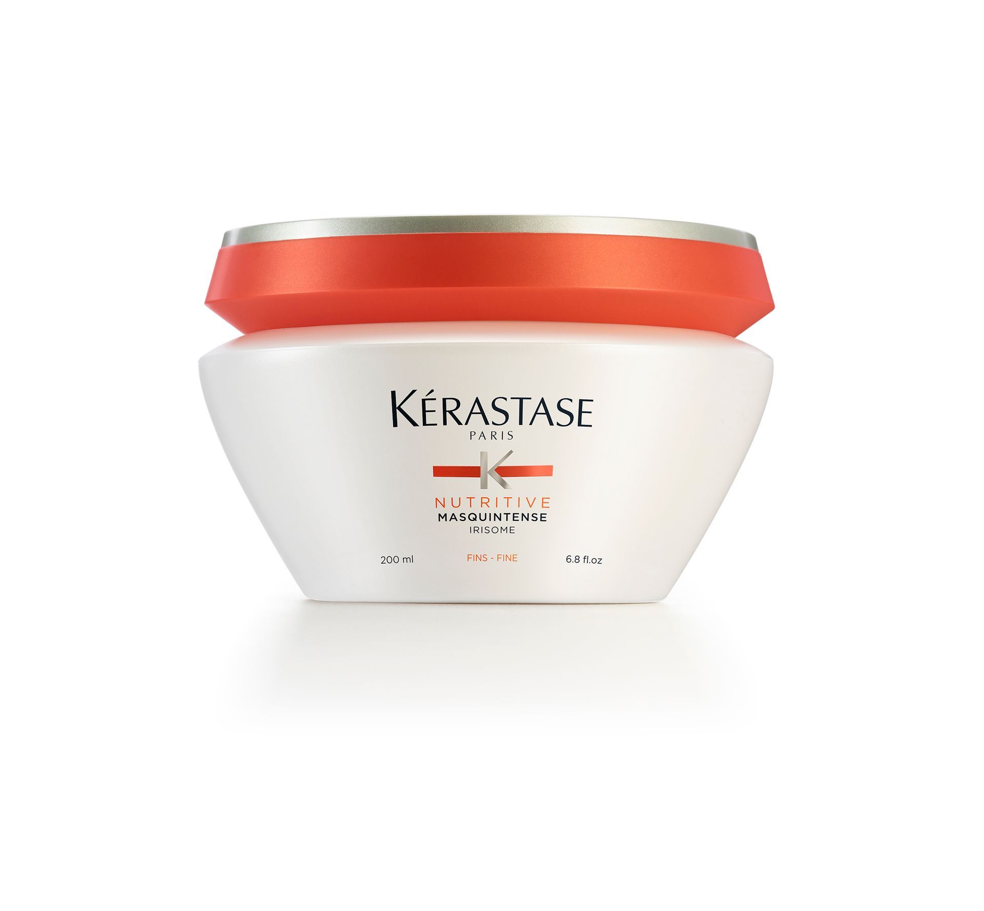 A white Kérastase product with a red lid
