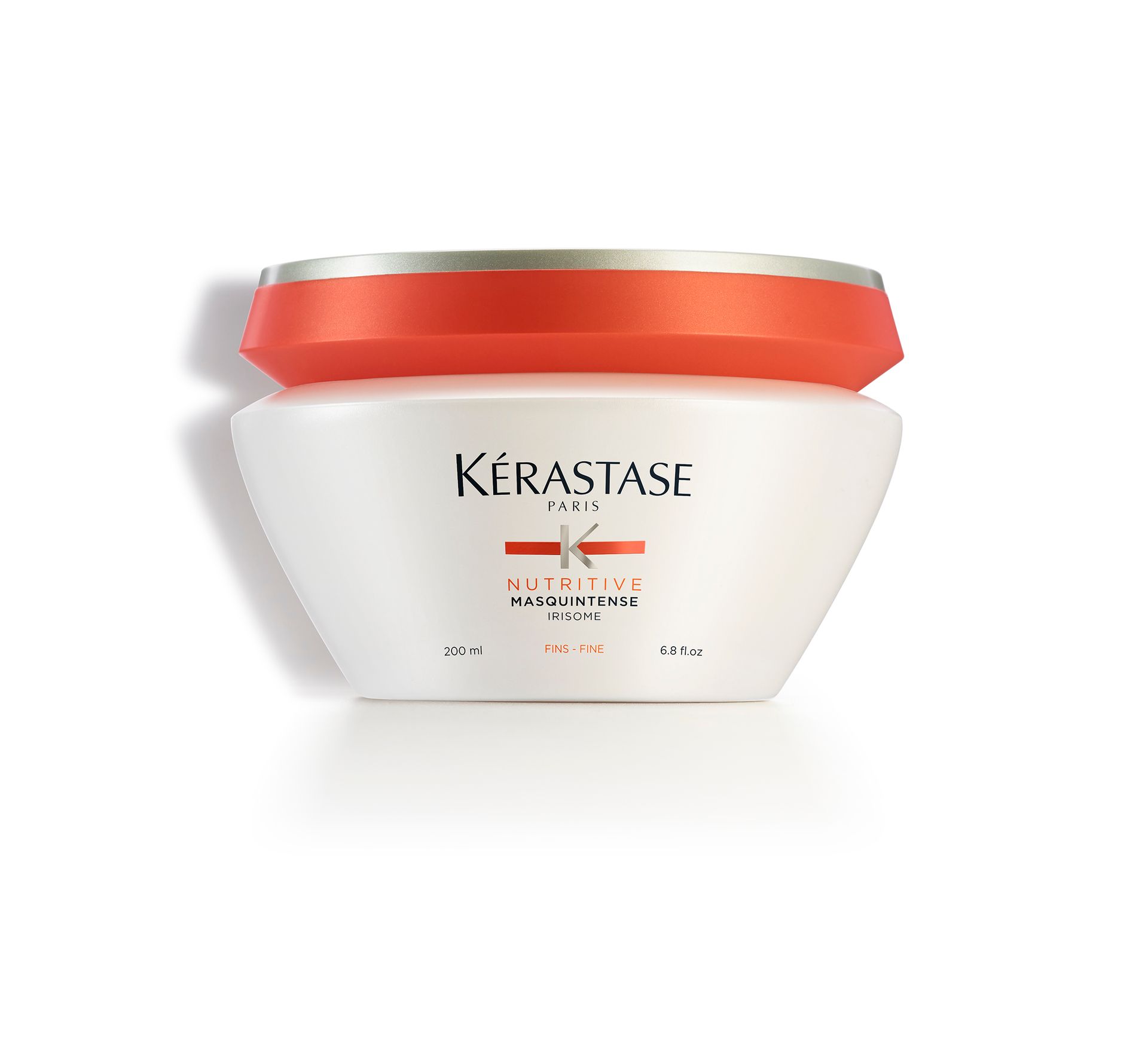 A white Kérastase product with a red lid