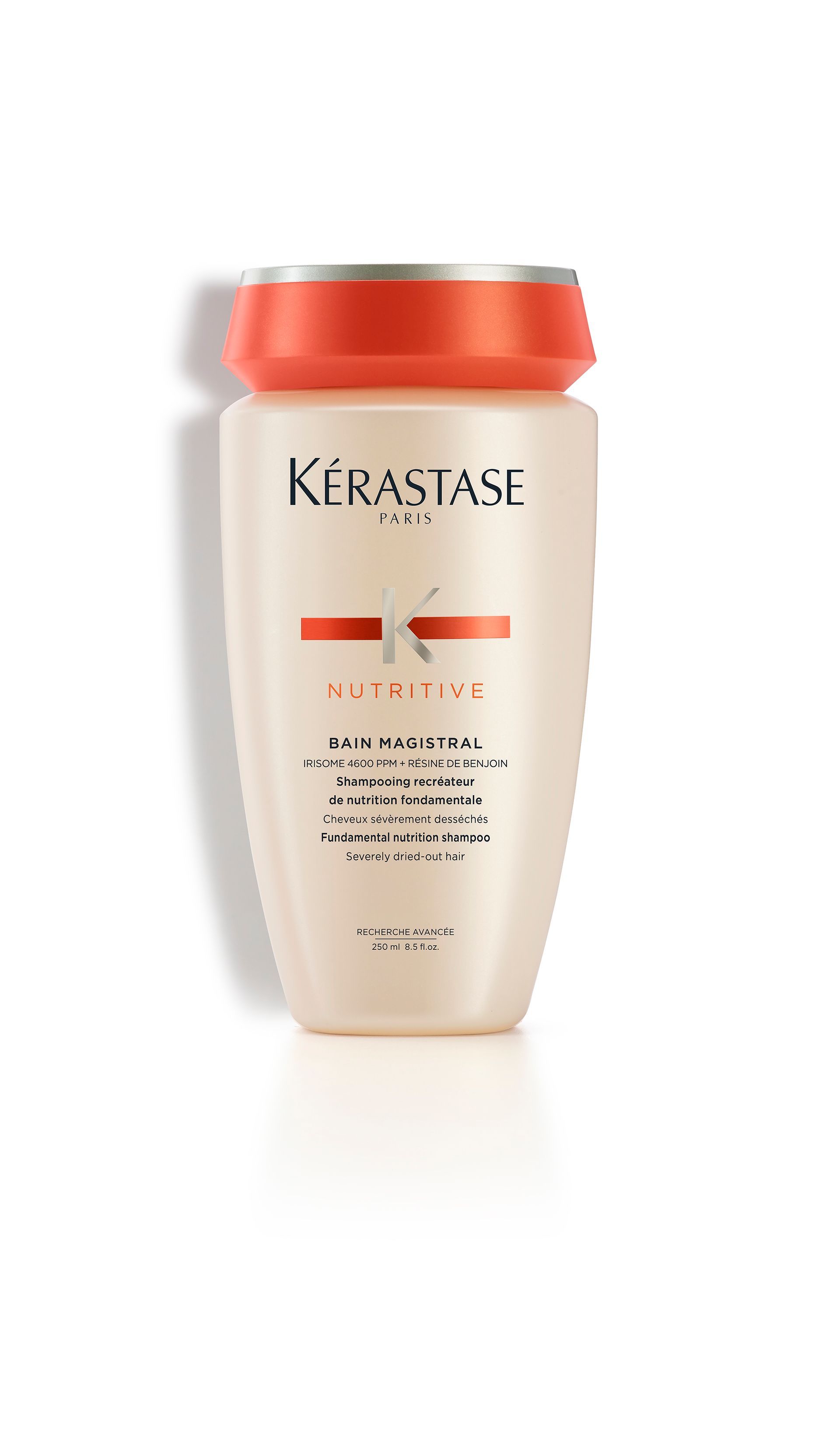 A bottle of Kérastase shampoo on a white background.