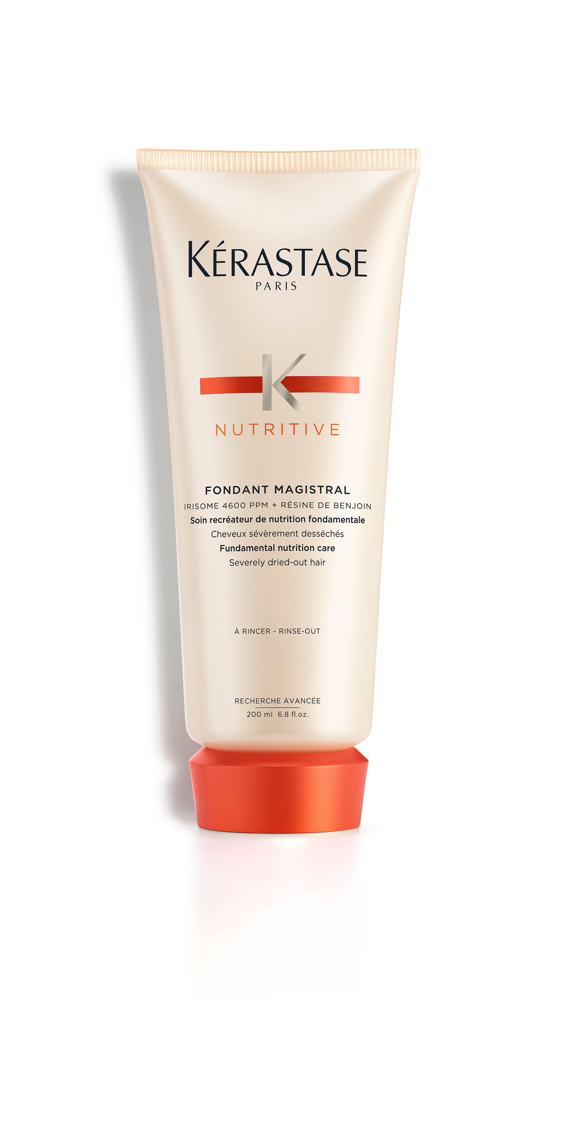 A bottle of Kérastase is sitting on a white surface