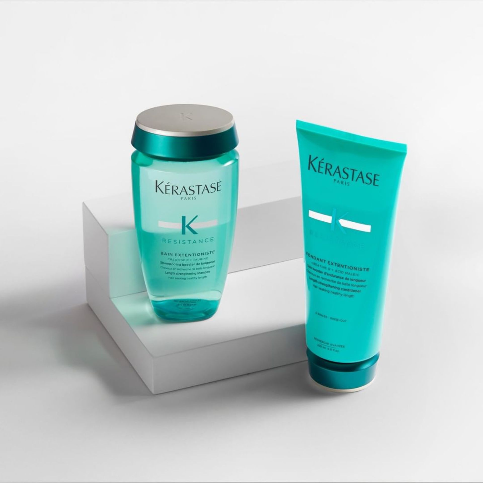 A bottle of Kérastase shampoo and a bottle of Kérastase conditioner