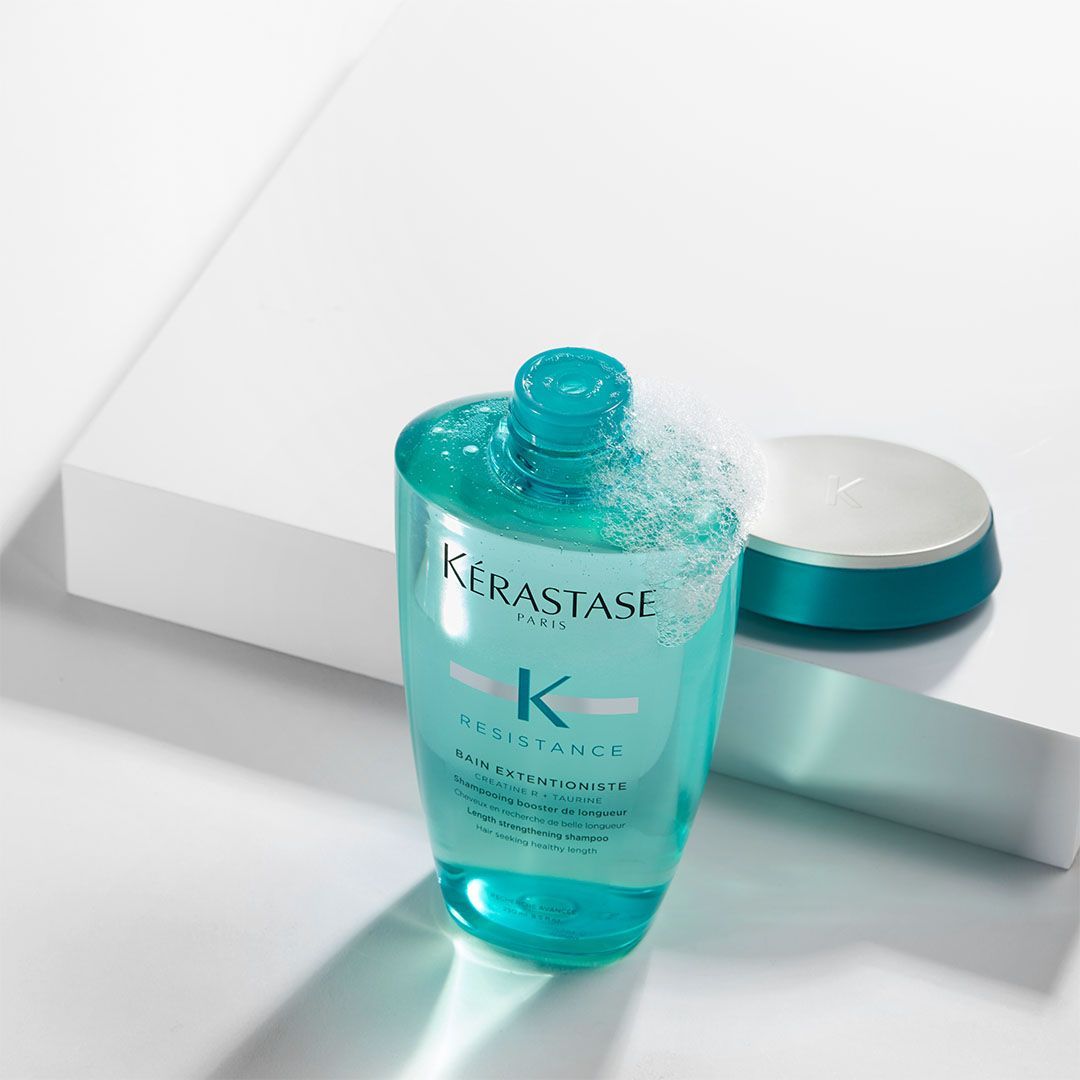 A bottle of Kérastase shampoo is sitting on a table