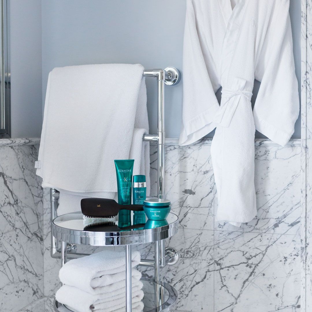 A bathroom with a bathrobe hanging on the wall