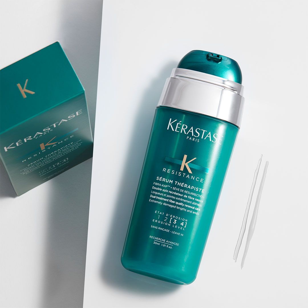 A bottle of Kérastase is sitting next to a box