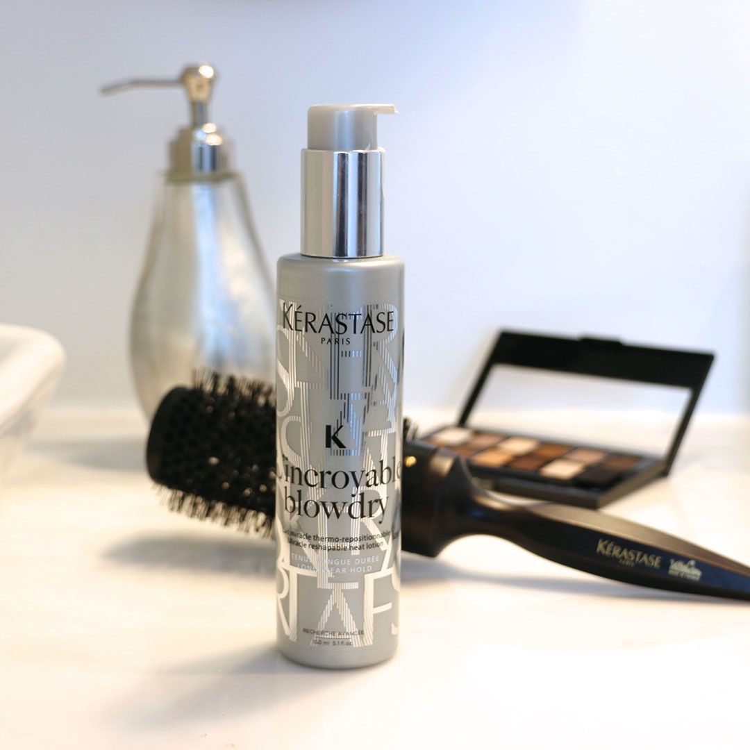 A bottle of Kérastase hair product sits on a counter