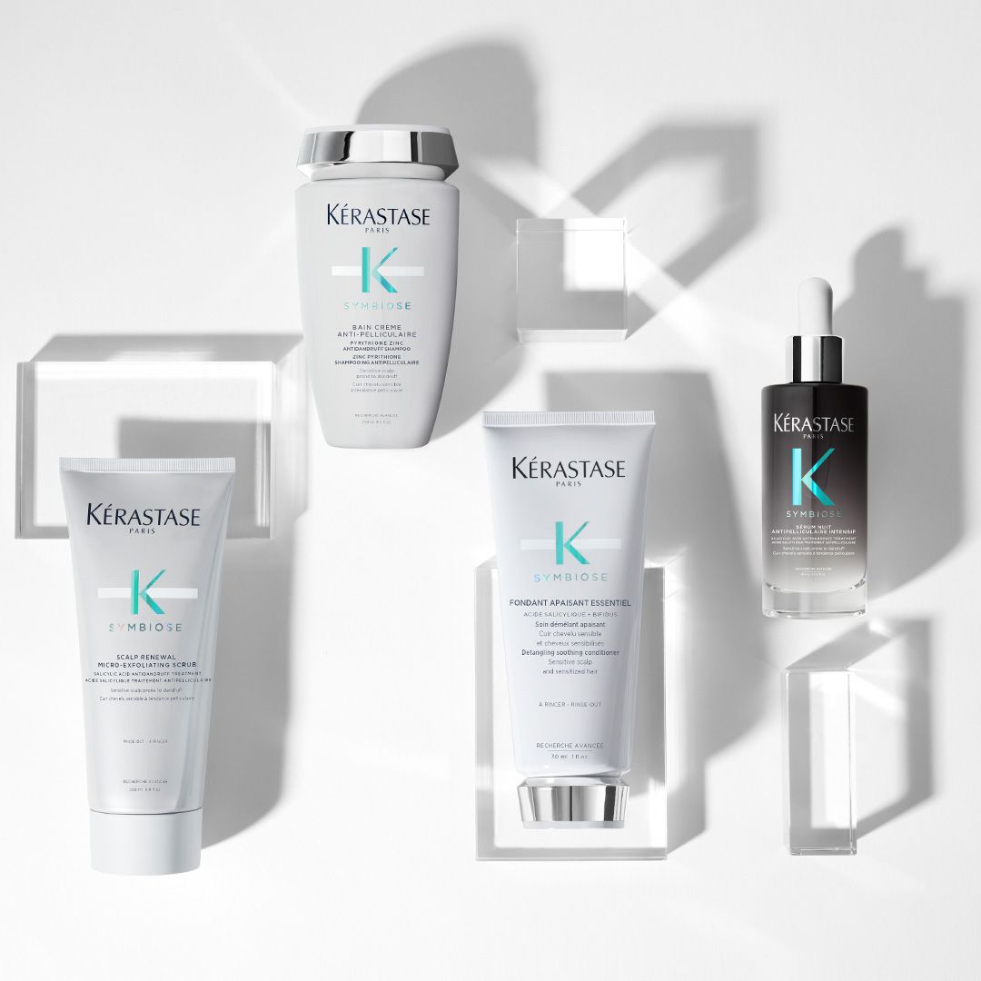 A variety of Kérastase products are displayed on a white surface