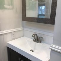 A bathroom sink with a mirror above it and a faucet.