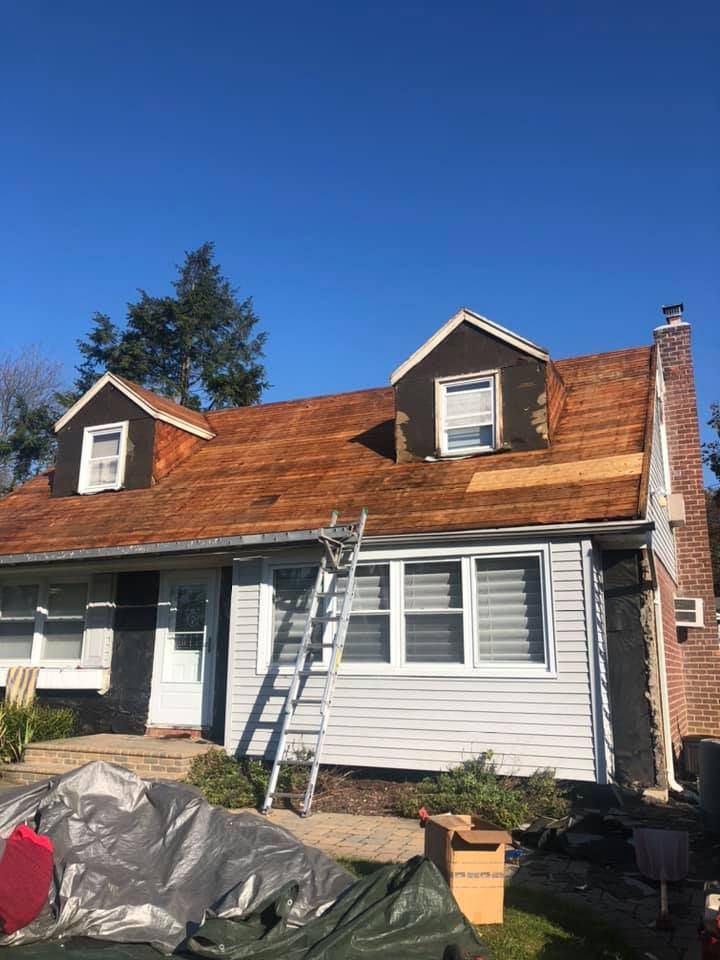 A house with a wooden roof and a ladder in front of it.