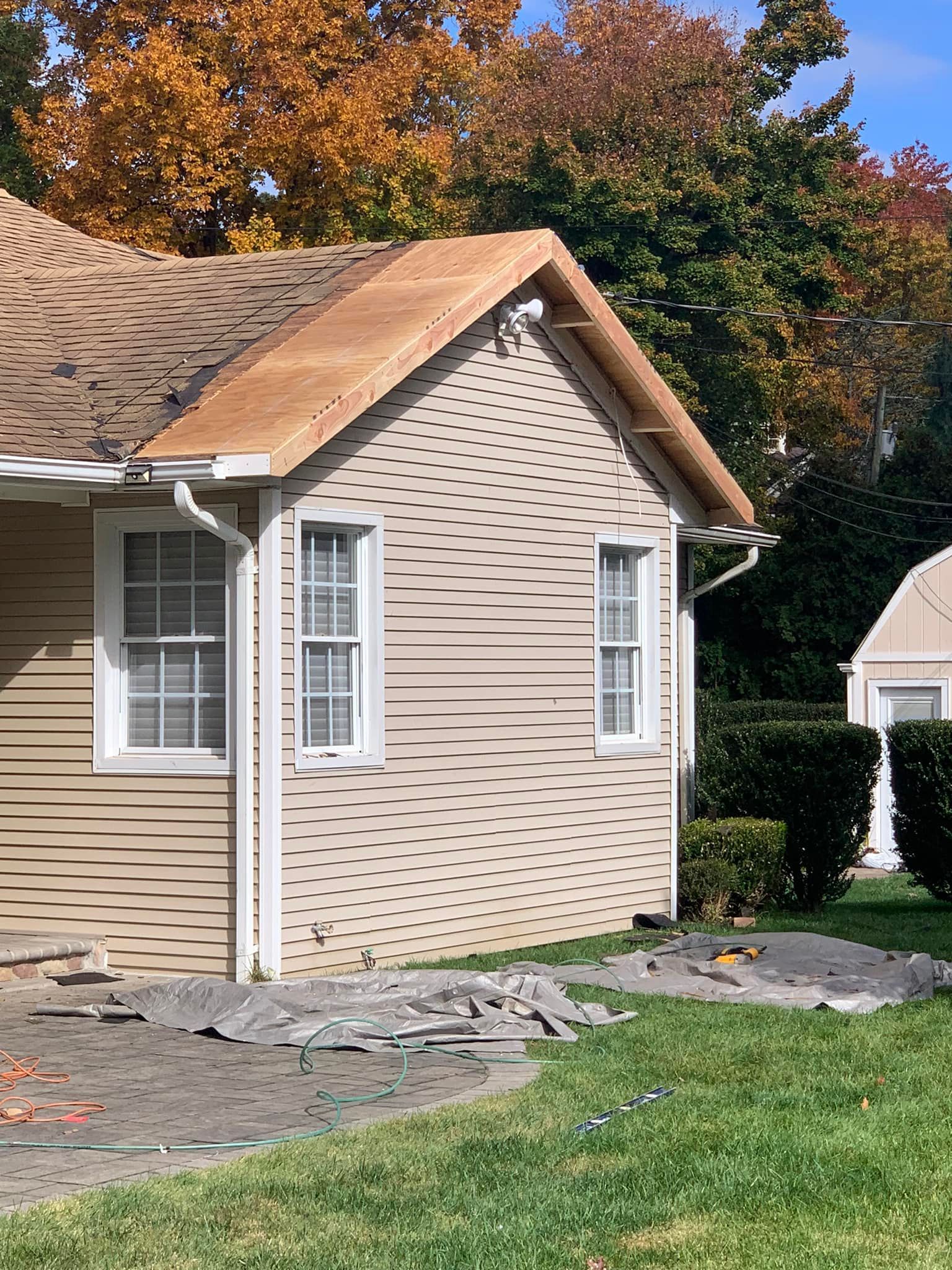 A small house with a wooden roof is being remodeled.
