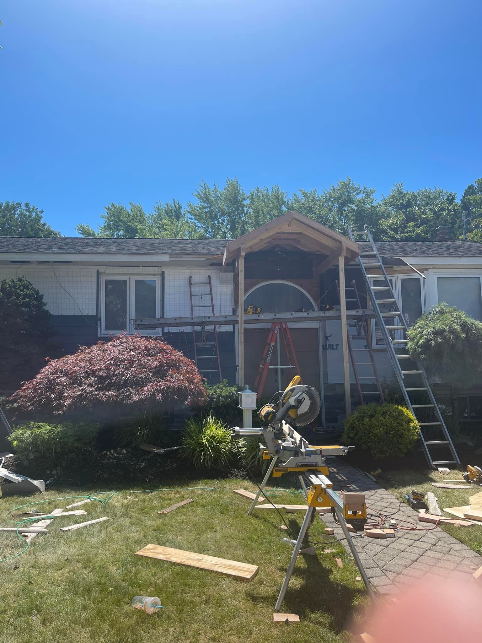 A house is being remodeled with a porch being built.