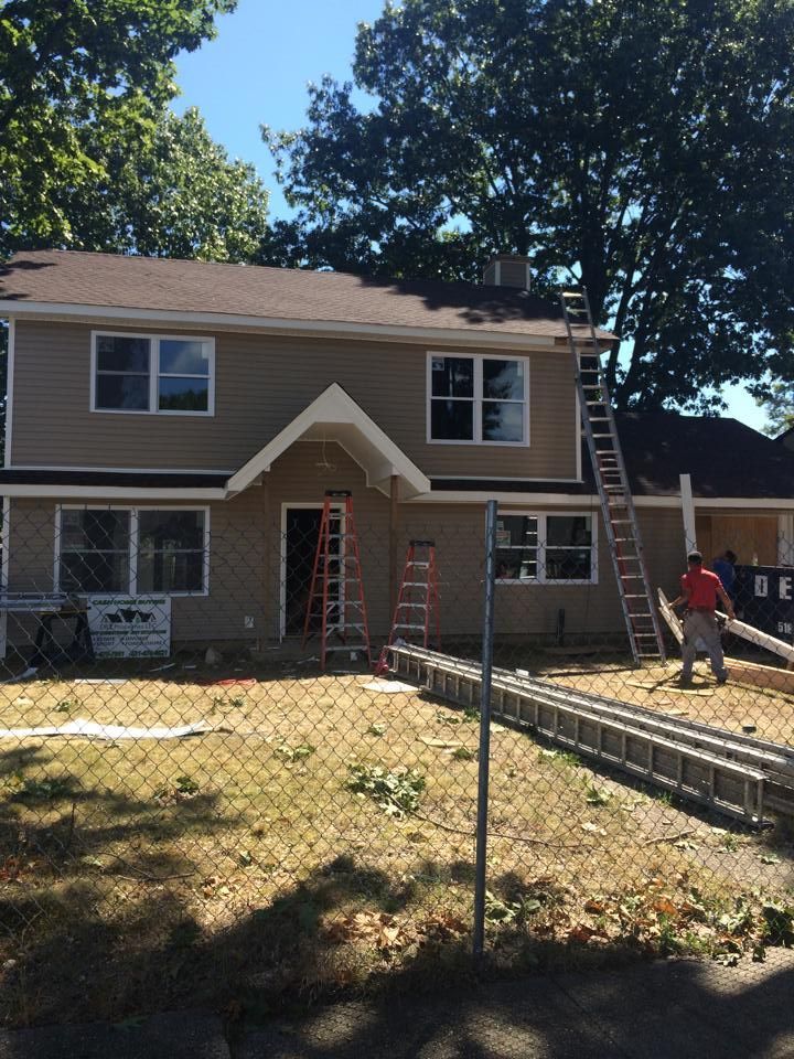 A house that is being remodeled with a ladder in front of it