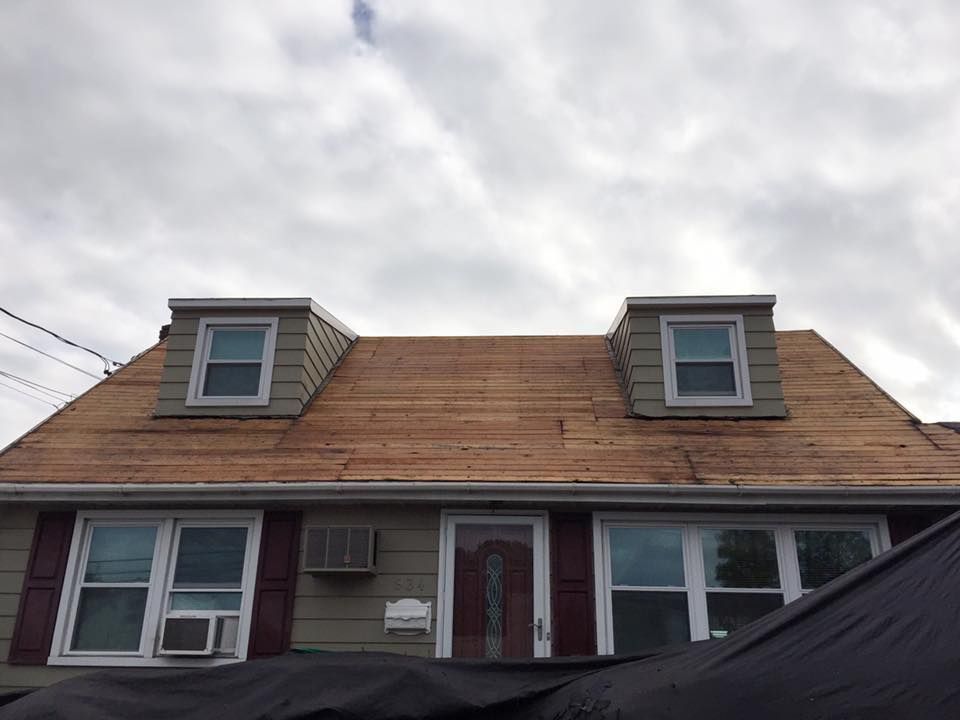 A house with a wooden roof and a lot of windows