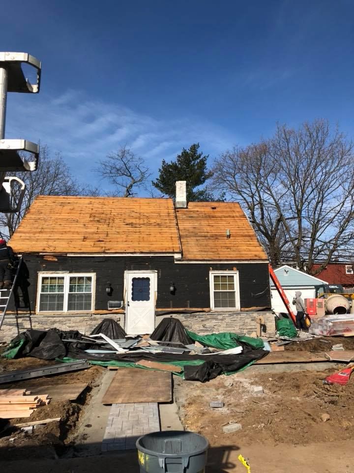 A house is being remodeled with a wooden roof.