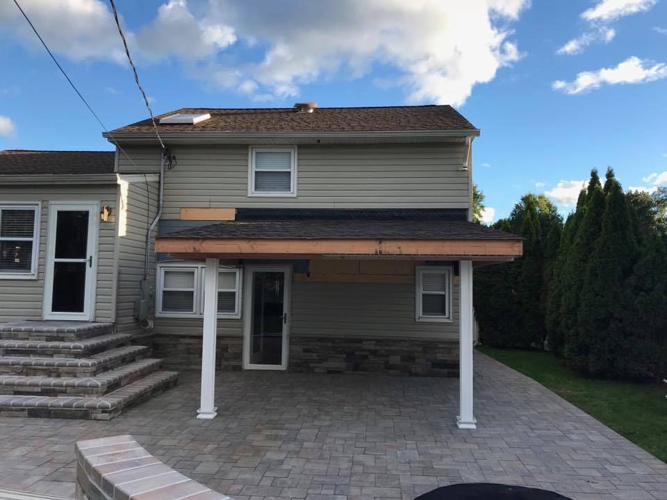 A house with a porch and stairs in front of it