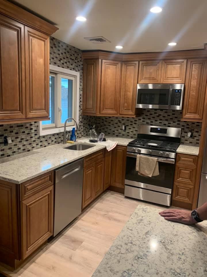 A kitchen with wooden cabinets and stainless steel appliances.