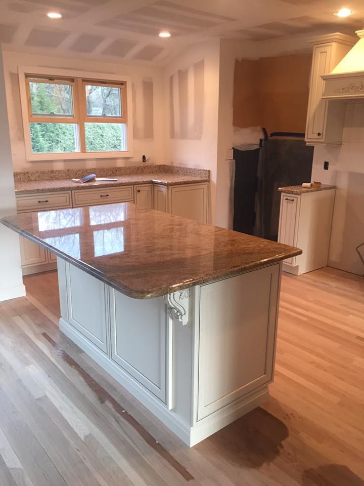A kitchen with a large island in the middle of it.