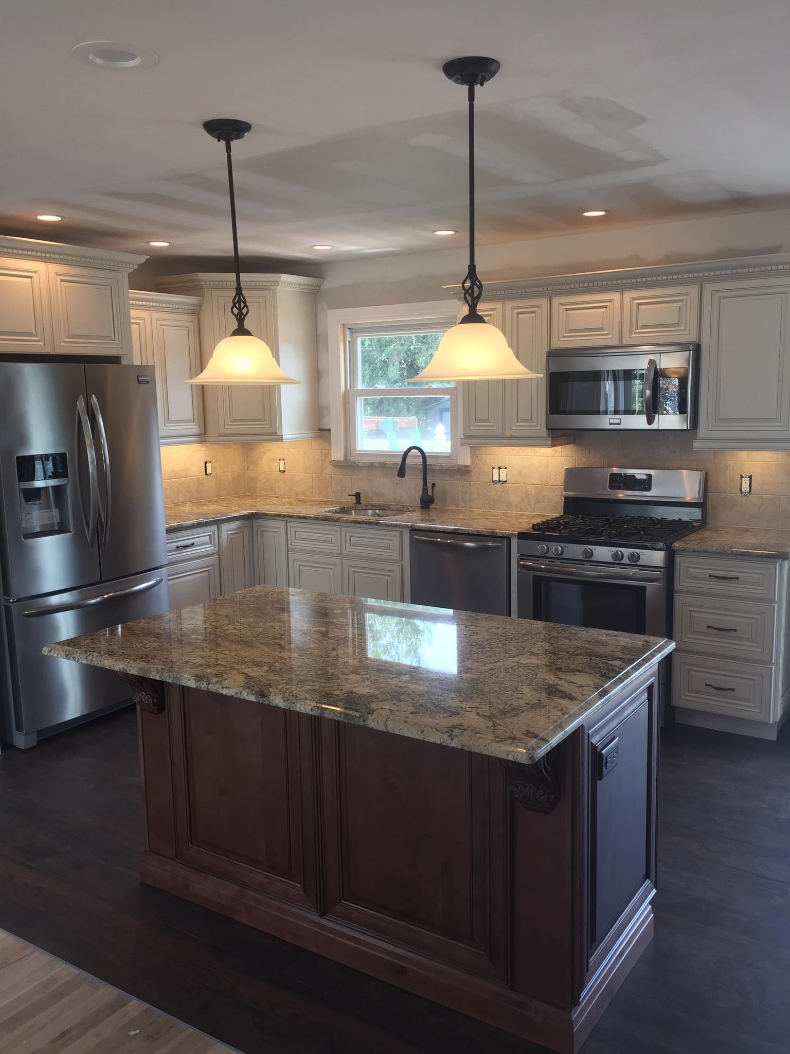 A kitchen with stainless steel appliances and granite counter tops