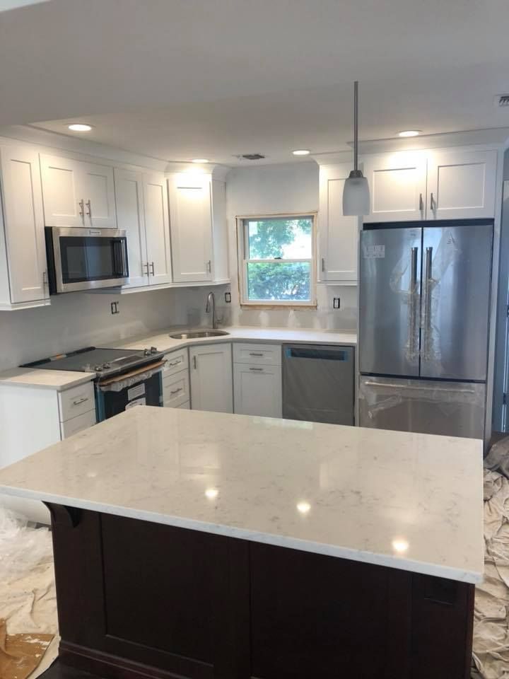 A kitchen with white cabinets and stainless steel appliances
