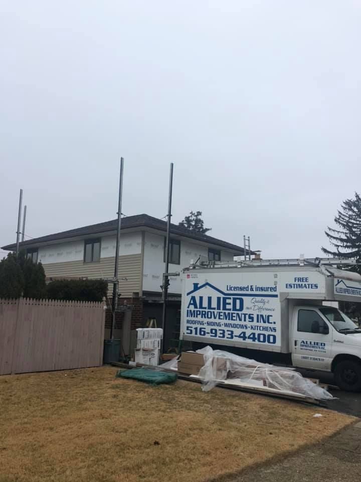 A white truck is parked in front of a house.