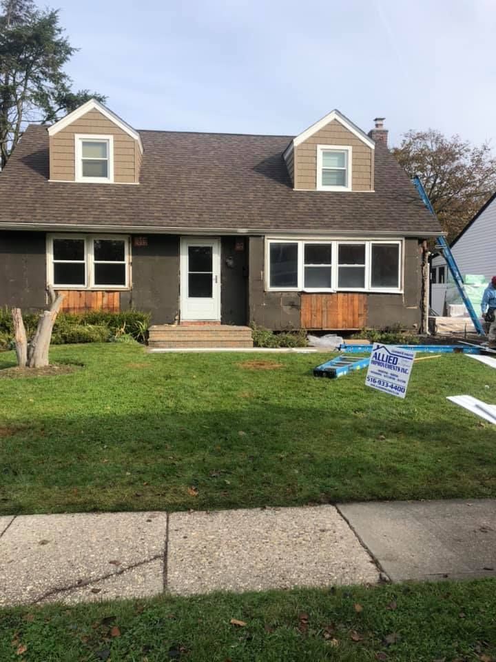 A house with a lot of windows is being painted.