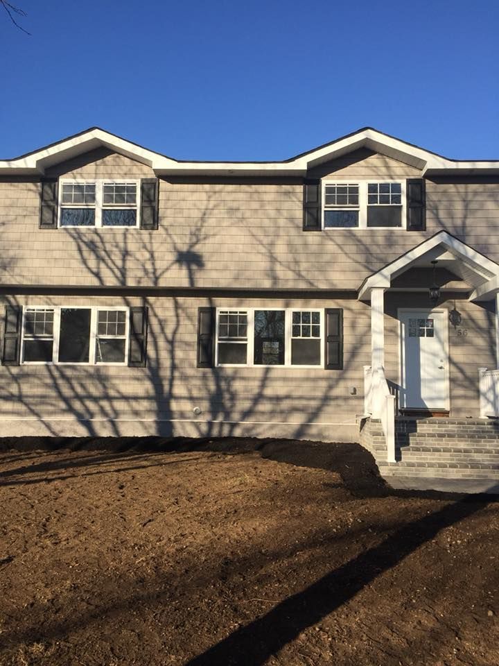 A house with a lot of windows and a porch