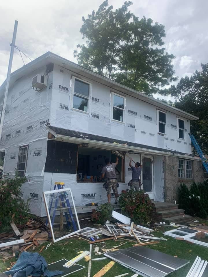 A house is being remodeled with a lot of windows being installed.