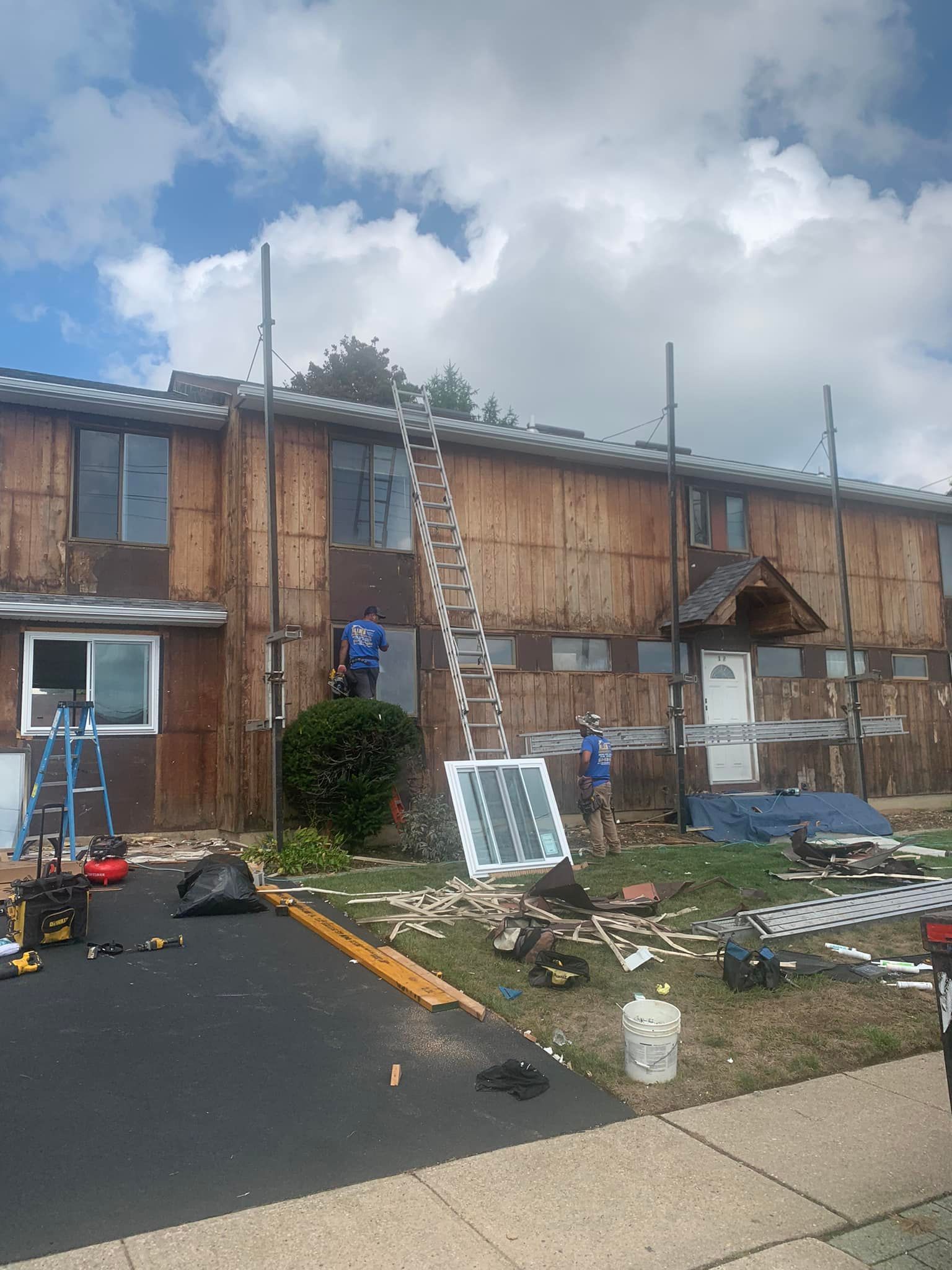 A group of people are working on the roof of a building.