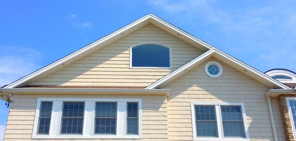 A large house with a blue sky in the background
